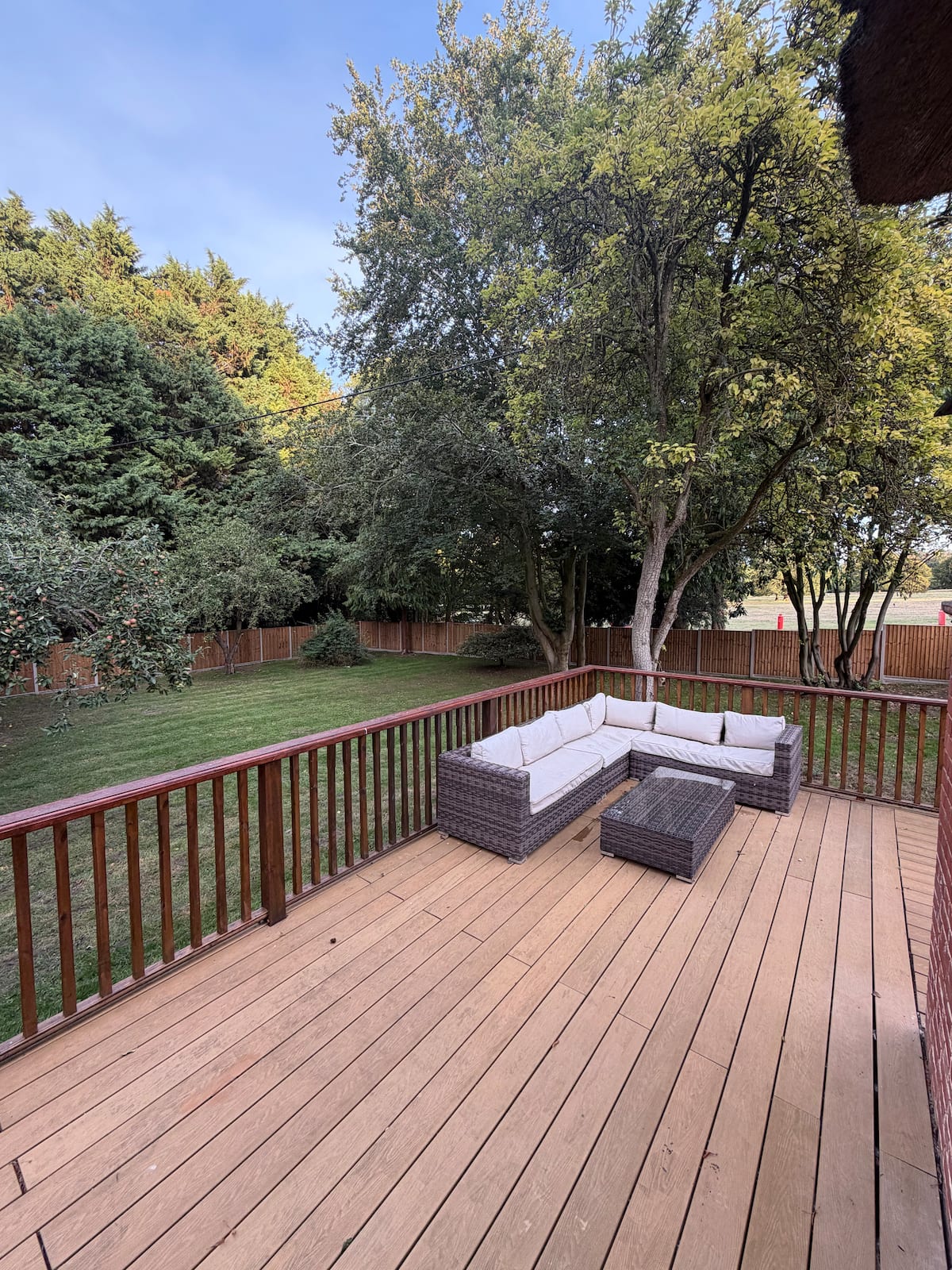 A deck and lawn overlooking the park
